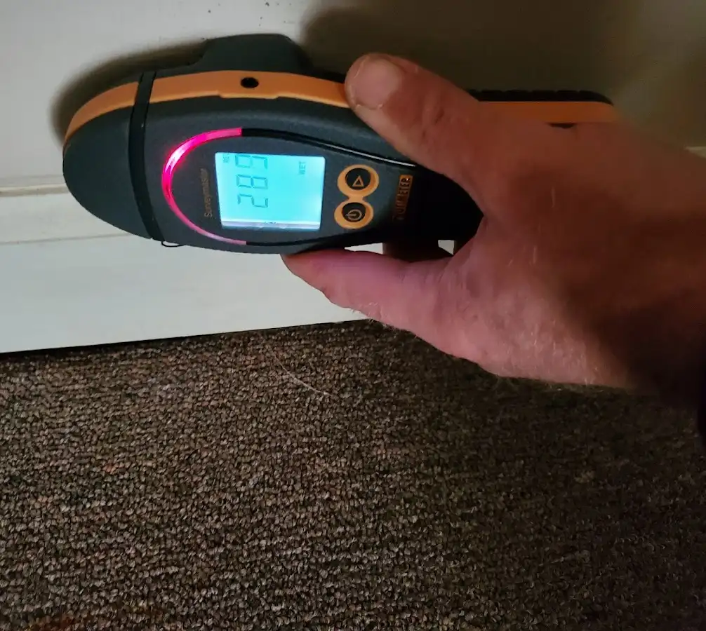 Moisture detection at baseboard during Storm Damage Restoration in Boston